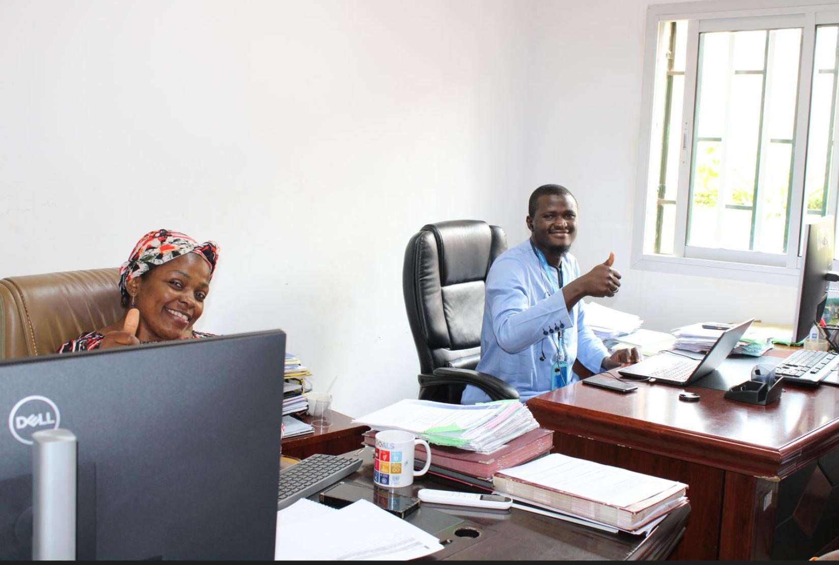 stable solar energy sparks happiness in project office staff, Sandrine and Amadou