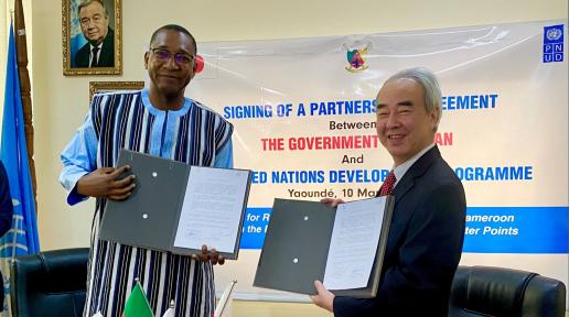 UNDP Cameroon’s Acting Resident Representative, Alassane Ba, and the Ambassador of Japan to Cameroon, H.E. Mr. TAKAOKA Nozomu presenting the signed agreement, during the ceremony. 